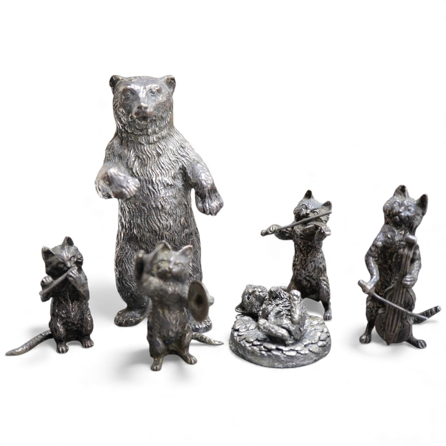 An Elizabeth II silver four piece miniature cat band by S.J. Rose & Son, Birmingham, 1976, tallest 58mm, together with a modern 925 miniature model of a standing grizzly bear and a modern silver model of a kitten(filled)